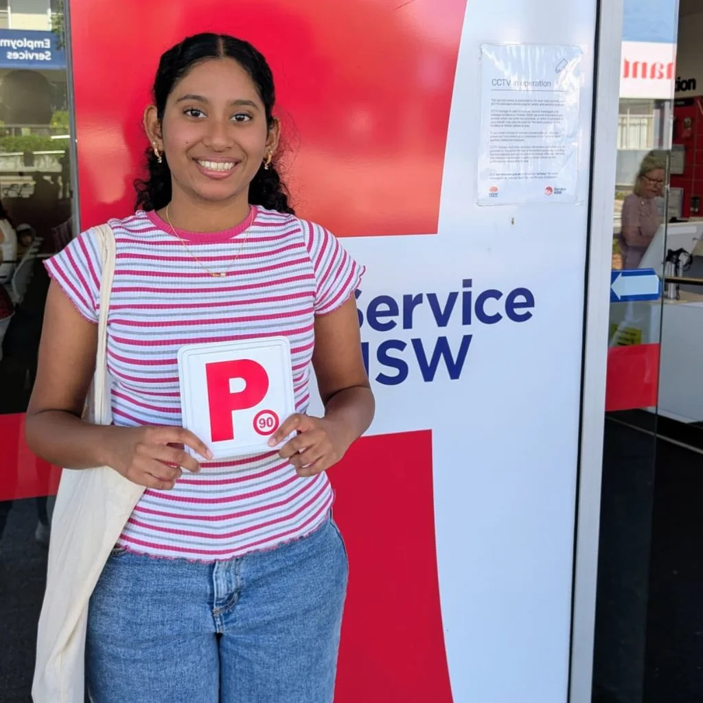 a woman smiling and  holding a card 