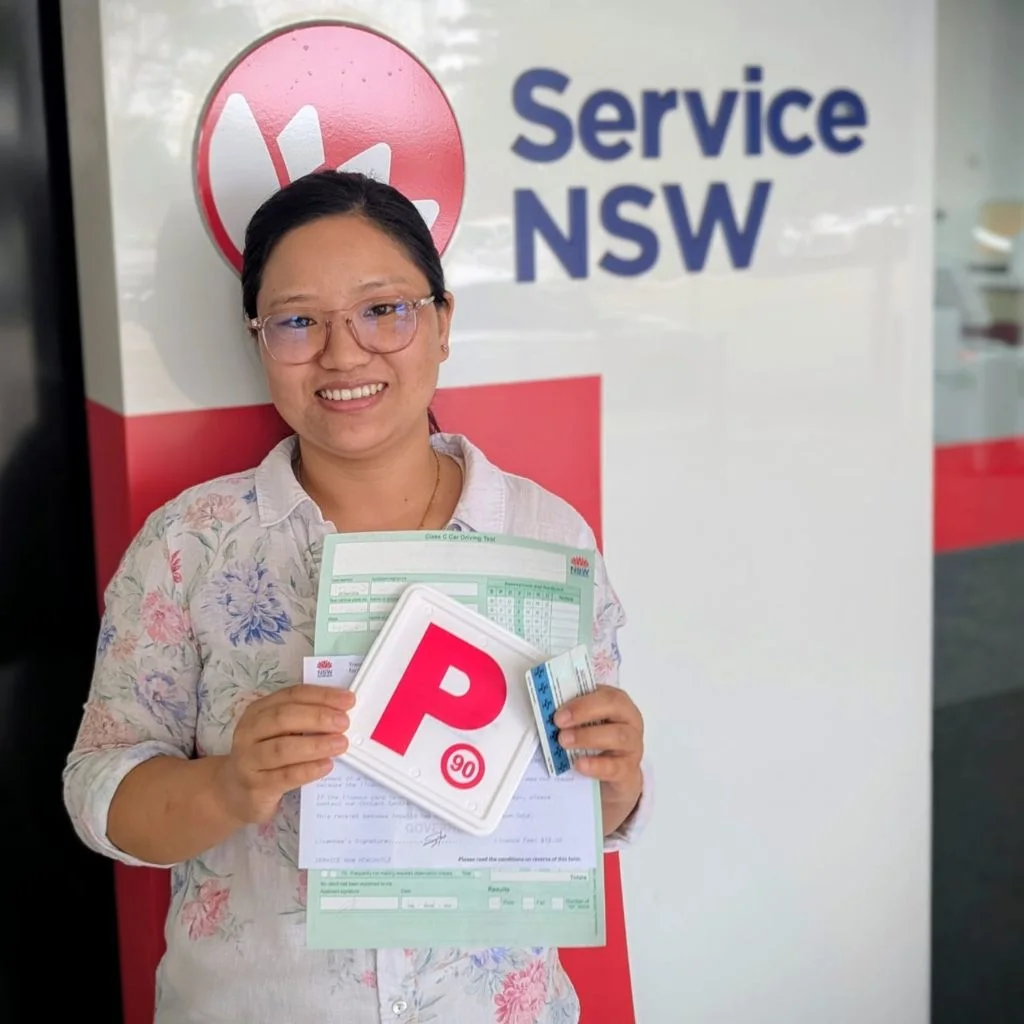 a woman smiling and  holding a card 