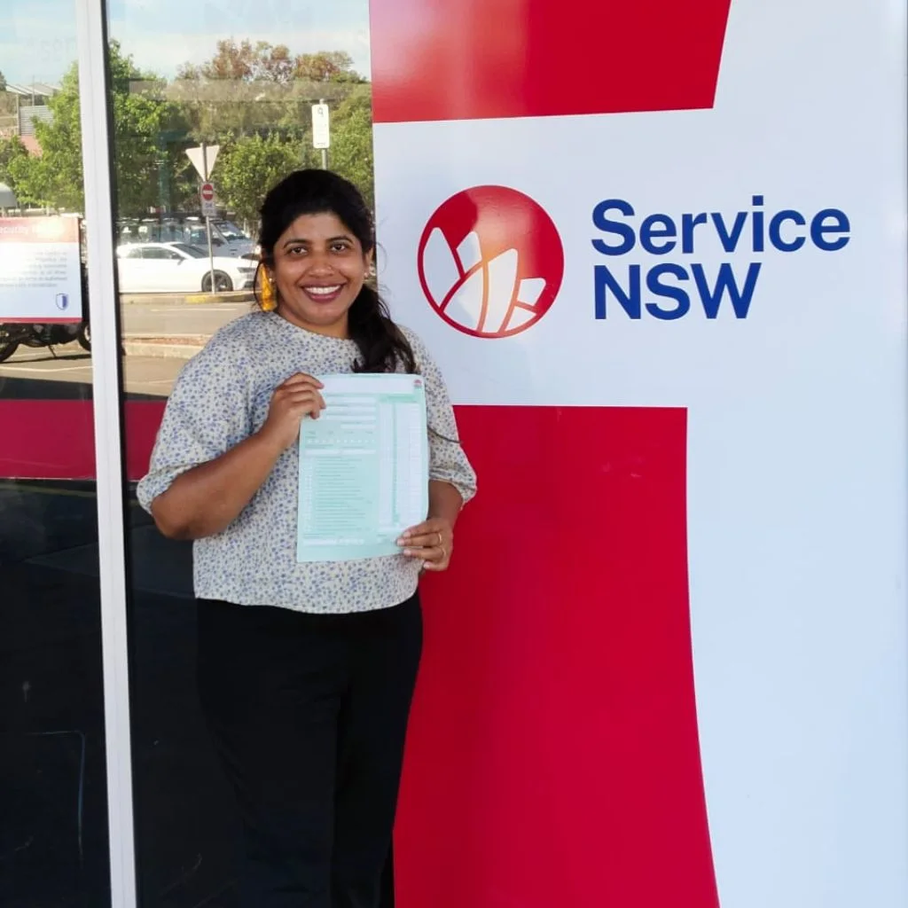 a woman smiling and  holding a card 