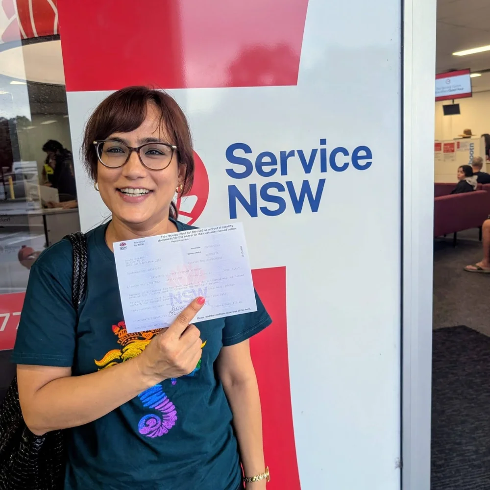 a woman smiling and holding a card